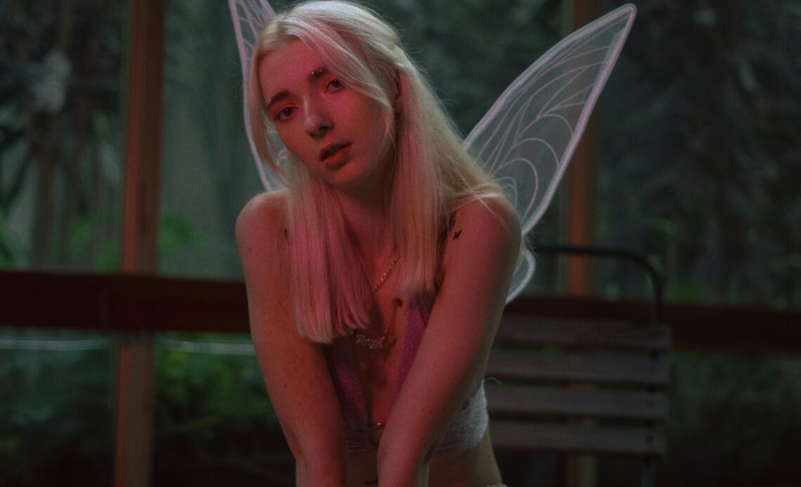 Woman dressed as a fairy, seated, mystical atmosphere