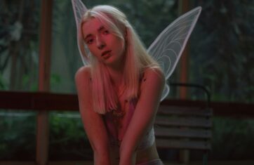 Woman dressed as a fairy, seated, mystical atmosphere