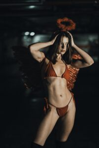 Woman wearing red angel costume posing outdoors