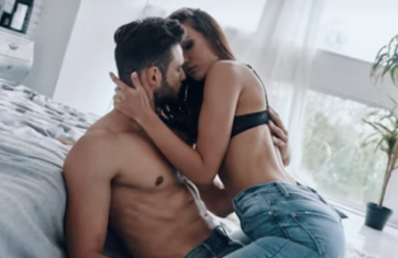 Couple embracing intimately in bedroom